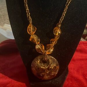 Bronze sea bead with bronze n gold amulet